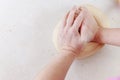 Hands chef knead dough for pizza. Knead dough with your hands.