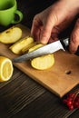 The hands of a chef with a knife cut fresh apples on a cutting board. Making apple jam at home Royalty Free Stock Photo