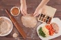 Hands chef rolling pastry for tacos