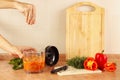 Hands of chef salt cooked vegetable mix in blender Royalty Free Stock Photo
