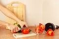Hands chefs cut red tomato on kitchen table Royalty Free Stock Photo