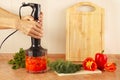 Hands chefs mixed red pepper and tomato in blender Royalty Free Stock Photo