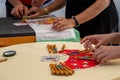 Hands of child and adult making bobbin lace. Colorful lace threads Royalty Free Stock Photo