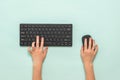 Hands of a child with a black keyboard and mouse on a light background. Royalty Free Stock Photo