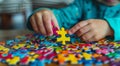 Hands of a child doing a puzzle at table Royalty Free Stock Photo