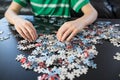 Hands of a child doing a puzzle