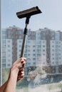 Hands of child hold cleaning products for window cleaner