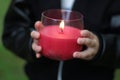 Hands of a child holding a candle, sign of hope concept Royalty Free Stock Photo