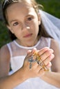 Hands of child holding rosary beads and cross Royalty Free Stock Photo