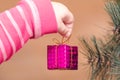 Hands of a child holding a small gift, decoration on a Christmas tree Royalty Free Stock Photo