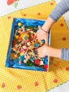 Hands of a child inside a candy box. Royalty Free Stock Photo