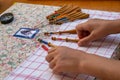 Hands of child making bobbin lace. Colorful lace threads Royalty Free Stock Photo