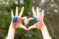 Hands of child painted in American flag color in heart shape. Patriotic holiday. Independence Day, Flag Day, 4th July Royalty Free Stock Photo