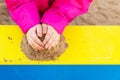 The hands of a child playing with  sand. Royalty Free Stock Photo