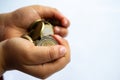 The hands of a child up close holding isolated euro coins