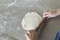 The hands of a child who is learning to prepare their own pizza dough at home. Learn to cook by yourself at home concept