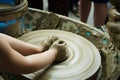 Hands of a child working the clay