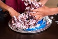 Hands of children destroying cake.