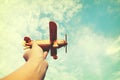 Hands of children holding a toy plane