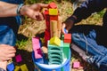 Hands of children playing with colored blocks on a sunny summer day Royalty Free Stock Photo