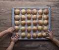 hands of children reaching for fresh baked buns