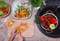 Hands chopping yellow bell pepper for a vegetable salad - health