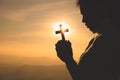 Hands of a Christian Women holding a cross while praying to God, Religious beliefs, Copy space