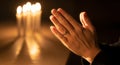 Prayer Hand Glowing Under Candlelight Expressing Peace, Reflection, and Silent Moments of Devotion-(AI Generated) Royalty Free Stock Photo