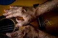 Hands of a classical guitarist on top of the guitar. Study of classical music