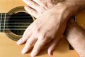 Hands of a classical guitarist on top of the guitar. Study of classical music Royalty Free Stock Photo