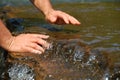 Hands in Clean Running Water of Stream