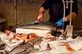 Hands cleaning a fish fishmonger