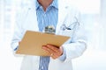Hands, clipboard and man doctor a hospital for planning, schedule or surgery checklist closeup. Healthcare, compliance Royalty Free Stock Photo