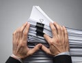 Hands Clipping and Organizing Stacked Documents with Binder Clip Royalty Free Stock Photo