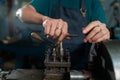 Hands close-up of Asian craftsmen, skilled craftsmen, skillfully mastering lathes, in a small family-owned factory