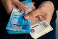 Hands close-up holding two bundles of Russian money, two thousandth and five thousandth bills Royalty Free Stock Photo