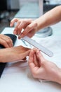 Hands close-up, manicure smoothes with nail file Royalty Free Stock Photo