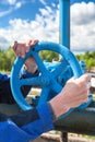 Hands close-up of manual worker turning stop-gate valve Royalty Free Stock Photo