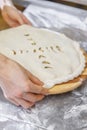 Hands closing the Ossetian pie stuffed with minced meat Royalty Free Stock Photo