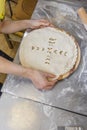 Hands closing the Ossetian pie stuffed with minced meat Royalty Free Stock Photo