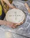 Hands closing the Ossetian pie stuffed with minced meat Royalty Free Stock Photo