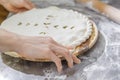 Hands closing the Ossetian pie stuffed with minced meat Royalty Free Stock Photo