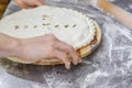 Hands closing the Ossetian pie stuffed with minced meat Royalty Free Stock Photo