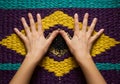 Hands on colorful patterned surface Royalty Free Stock Photo