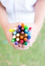 Hands with colourful crayons