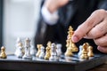 Hands of confident businessman playing chess game to development analysis new strategy plan, leader and teamwork concept for win Royalty Free Stock Photo