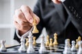 Hands of confident businessman playing chess game to development analysis new strategy plan, leader and teamwork concept for win Royalty Free Stock Photo