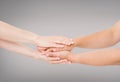 Hands connected together on grey background - concept of united team Royalty Free Stock Photo