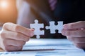 Hands connecting jigsaw puzzle. Business solutions, success and strategy concept. Close up photo with selective focus Royalty Free Stock Photo