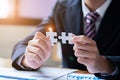 Hands connecting jigsaw puzzle. Business solutions, success and strategy concept. Close up photo with selective focus Royalty Free Stock Photo